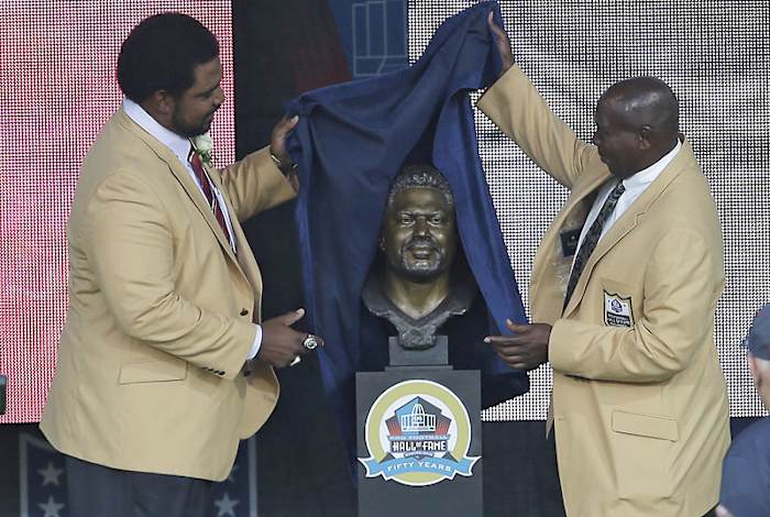 Seventeen years after he made him the Ravens’ first draft pick, Newsome helped Jonathan Ogden unveil his bust in Canton this summer. (Tony Dejak/AP)